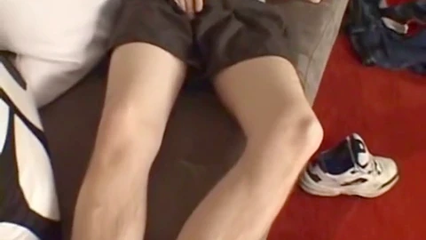 Kyle strokes his hairy cock and indulges in some foot play with his mate